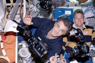 Mission Specialist Wolf and Pilot Edwards exhibit cameras on the middeck of the Orbiter Endeavour.